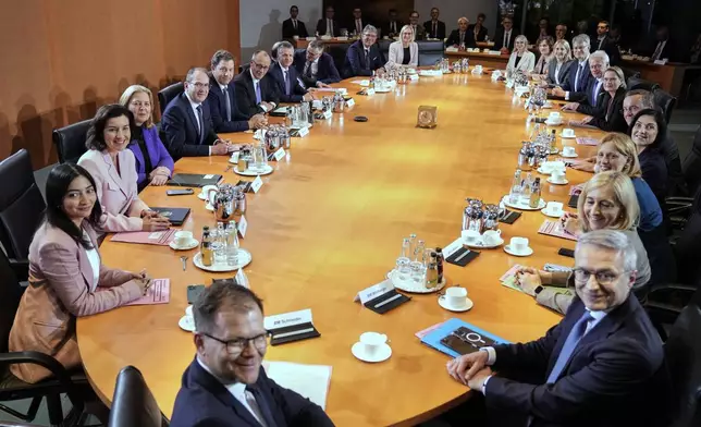 Newly-elected German Chancellor Friedrich Merz, 6th from left, and members of the new cabinet attend the first cabinet meeting, at the chancellery in Berlin, late Tuesday, May 6, 2025. (AP Photo/Ebrahim Noroozi)