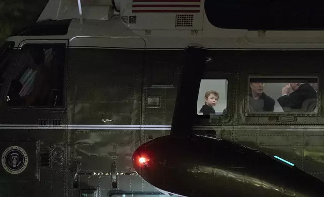 FILE - President Donald Trump speaks with Elon Musk as his son X Æ A-Xii looks on as they arrive on Marine One at the South Lawn of the White House in Washington, April 13, 2025. (AP Photo/Jose Luis Magana, File)