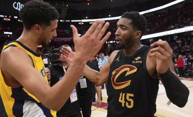 Indiana Pacers guard Tyrese Haliburton, left, and Cleveland Cavaliers guard Donovan Mitchell greet each other after the Pacers defeated the Cleveland Cavaliers 114-105 in Game 5 of an Eastern Conference semifinal NBA basketball playoff Tuesday, May 13, 2025, in Cleveland. (AP Photo/Sue Ogrocki)