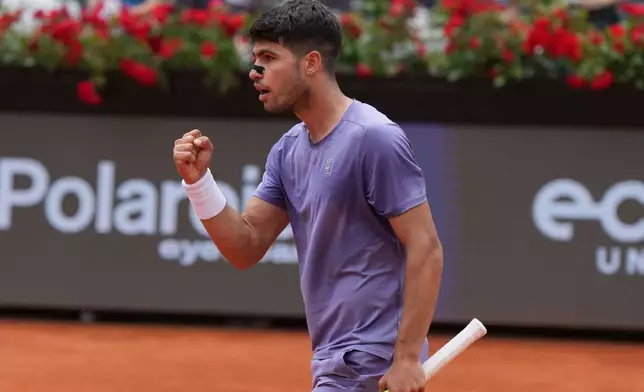 Spain's Carlos Alcaraz celebrates a point from Serbia's Dusan Lajovic during the Italian Open tennis tournament in Rome, Friday May 9, 2025. (Alfredo Falcone/LaPresse via AP)