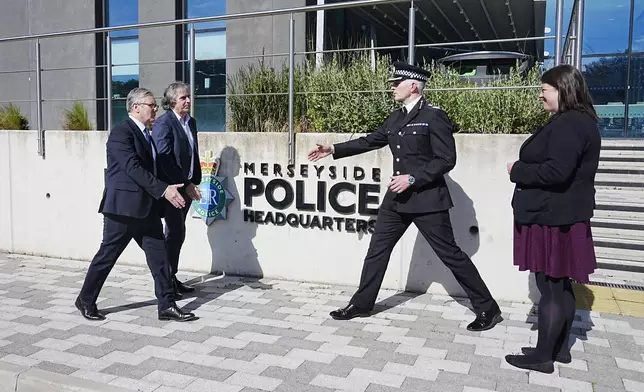Britain's Prime Minister Keir Starmer, left, meets with Police and Crime Commissioner Emily Spurrell, right, Deputy Chief Constable Chris Green, second right, and the Mayor of Liverpool City Region, Steve Rotheram, at Merseyside Police Headquarters, in Liverpool, England, Wednesday, May 28, 2025. (Peter Byrne/Pool photo via AP)