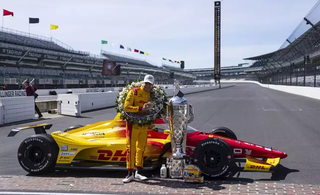 Indianapolis 500 champion Alex Palou, of Spain, poses with the Borg-Warner Trophy during the traditional winners photo session at Indianapolis Motor Speedway in Indianapolis, Monday, May 26, 2025. (AP Photo/Michael Conroy)