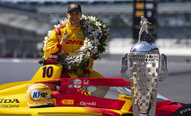 Indianapolis 500 champion Alex Palou, of Spain, poses with the Borg-Warner Trophy during the traditional winners photo session at Indianapolis Motor Speedway in Indianapolis, Monday, May 26, 2025. (AP Photo/Michael Conroy)