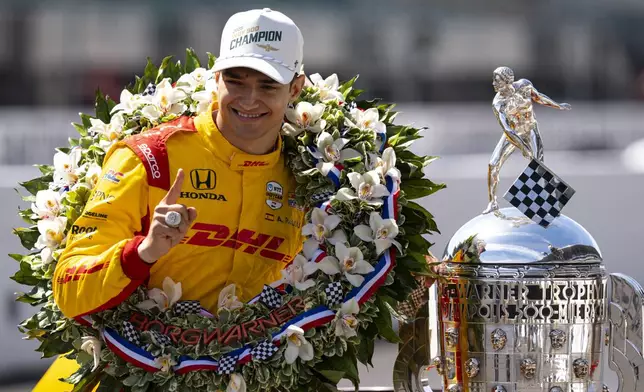Indianapolis 500 champion Alex Palou, of Spain, poses with the Borg-Warner Trophy during the traditional winners photo session at Indianapolis Motor Speedway in Indianapolis, Monday, May 26, 2025. (AP Photo/Michael Conroy)