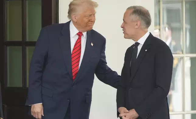 Canadian Prime Minister Mark Carney is greeted by President Donald Trump as he arrives at the West Wing of the White House, Tuesday, May 6, 2025, in Washington. (AP Photo/Mark Schiefelbein)