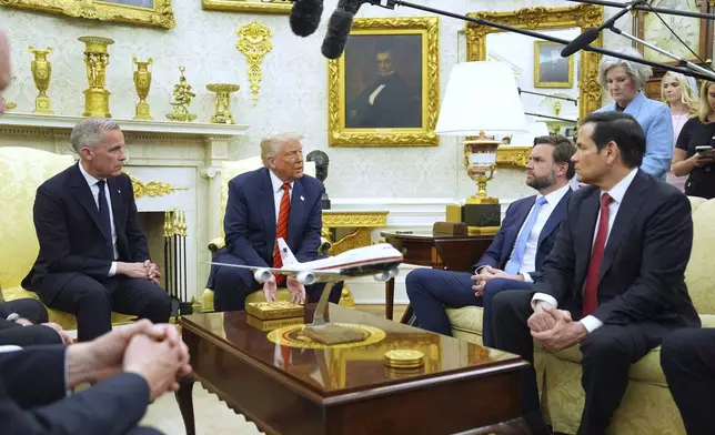 President Donald Trump meets Canadian Prime Minister Mark Carney in the Oval Office of the White House, Tuesday, May 6, 2025, in Washington. (AP Photo/Evan Vucci)