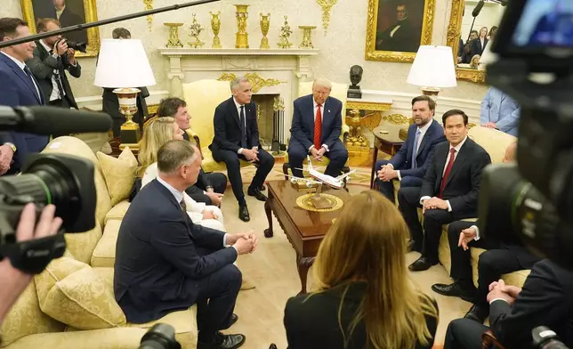 Canada Prime Minister Mark Carney and U.S. President Donald Trump engage in a meeting at the White House in Washington, Tuesday, May 6, 2025. (Adrian Wyld/The Canadian Press via AP)