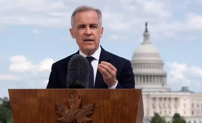 Canada's Prime Minister Mark Carney speaks with media during a news conference at the Canadian embassy in Washington, Tuesday, May 6, 2025. (Adrian Wyld/The Canadian Press via AP)