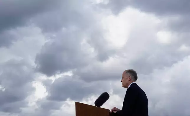 Storm clouds pass by as Canada's Prime Minister Mark Carney speaks during a news conference at the Canadian embassy in Washington, Tuesday, May 6, 2025. (Adrian Wyld/The Canadian Press via AP)