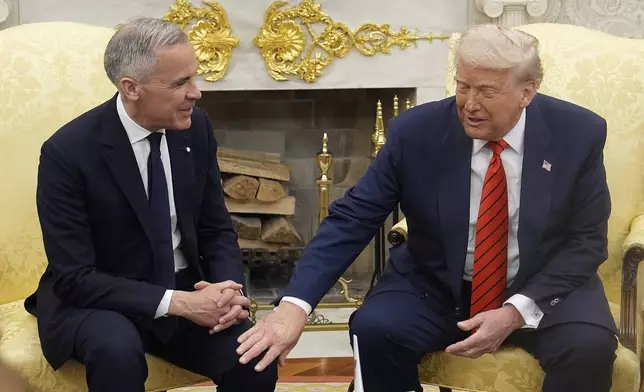 Canada Prime Minister Mark Carney and U.S. President Donald Trump engage in a meeting at the White House in Washington, Tuesday, May 6, 2025. (Adrian Wyld/The Canadian Press via AP)