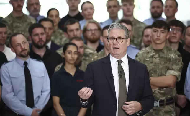 Britain's Prime Minister Keir Starmer speaks to members of staff during a visit to Leonardo, one of the biggest suppliers of defence and security equipment to the UK MOD, in Luton, England, Friday, May 2, 2025. (Henry Nicholls/Pool Photo via AP)