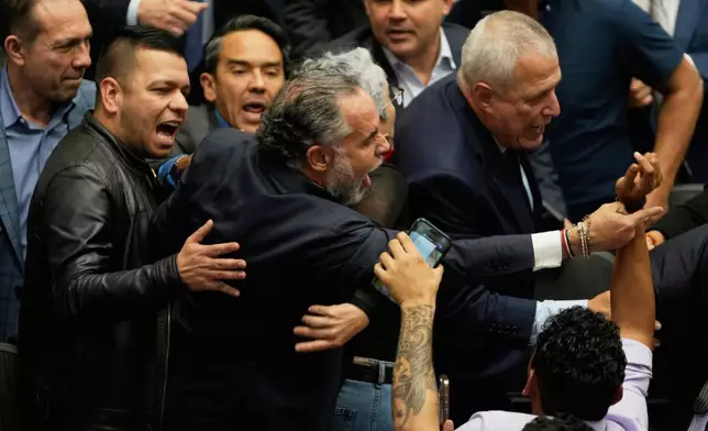 Colombian Interior Minister Armando Benedetti reacts after senators voted against a labor reform referendum proposed by the government, in Bogota, Colombia, Wednesday, May 14, 2025. (AP Photo/Fernando Vergara)