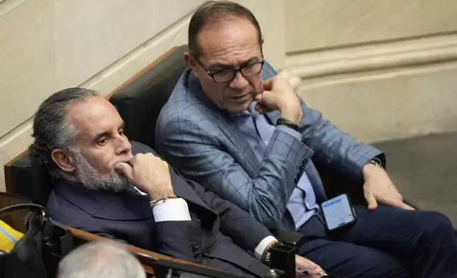 Colombian Interior Minister Armando Benedetti, left, and Labor Minister Antonio Sanguino gesture during a discussion on a referendum proposal on labor reform, in Bogota, Colombia, Wednesday, May 14, 2025. (AP Photo/Fernando Vergara)