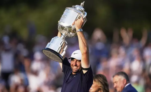 Scottie Scheffler holds the Wanamaker trophy after winning the PGA Championship golf tournament at the Quail Hollow Club, Sunday, May 18, 2025, in Charlotte, N.C. (AP Photo/George Walker IV)