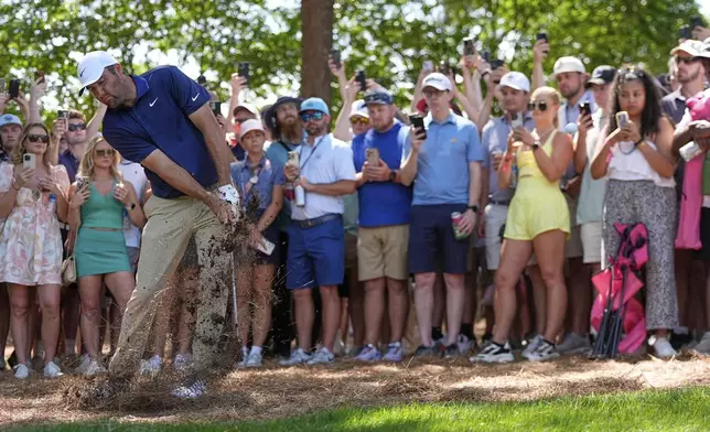 Scottie Scheffler hits from the pine straw on the first hole during the final round of the PGA Championship golf tournament at the Quail Hollow Club, Sunday, May 18, 2025, in Charlotte, N.C. (AP Photo/David J. Phillip)