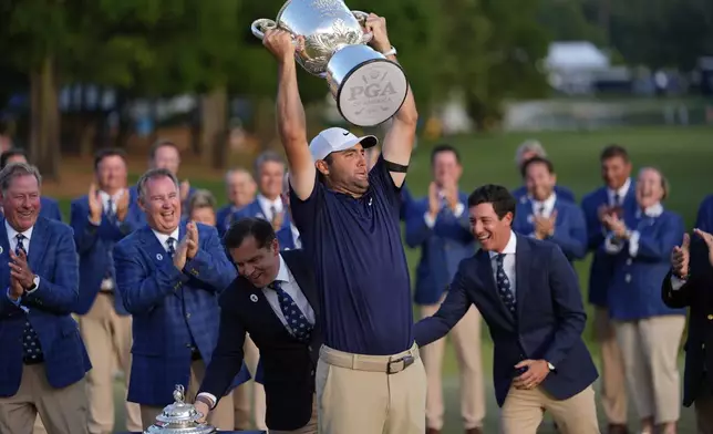 Scottie Scheffler holds the Wanamaker trophy after winning the PGA Championship golf tournament at the Quail Hollow Club, Sunday, May 18, 2025, in Charlotte, N.C. (AP Photo/David J. Phillip)