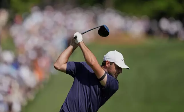 Scottie Scheffler hits his tee shot on the eighth hole during the final round of the PGA Championship golf tournament at the Quail Hollow Club, Sunday, May 18, 2025, in Charlotte, N.C. (AP Photo/David J. Phillip)