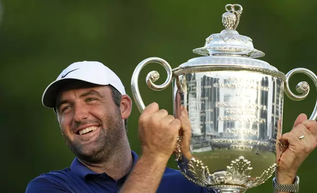 Scottie Scheffler holds the Wanamaker trophy after winning the PGA Championship golf tournament at the Quail Hollow Club, Sunday, May 18, 2025, in Charlotte, N.C. (AP Photo/Matt York)