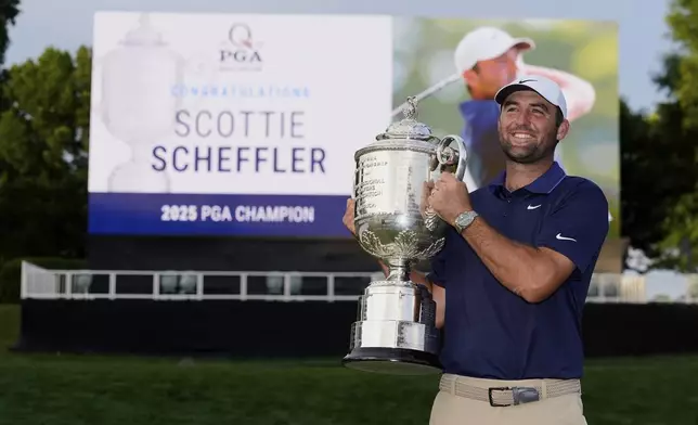 Scottie Scheffler poses with the Wanamaker trophy after winning the PGA Championship golf tournament at the Quail Hollow Club, Sunday, May 18, 2025, in Charlotte, N.C. (AP Photo/David J. Phillip)