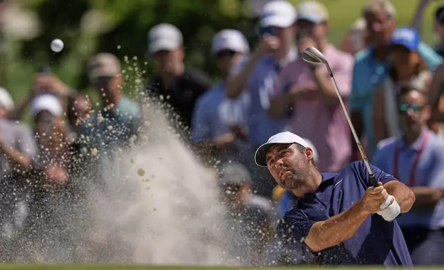 Scottie Scheffler hits from the bunker during the final round of the PGA Championship golf tournament at the Quail Hollow Club, Sunday, May 18, 2025, in Charlotte, N.C. (AP Photo/David J. Phillip)