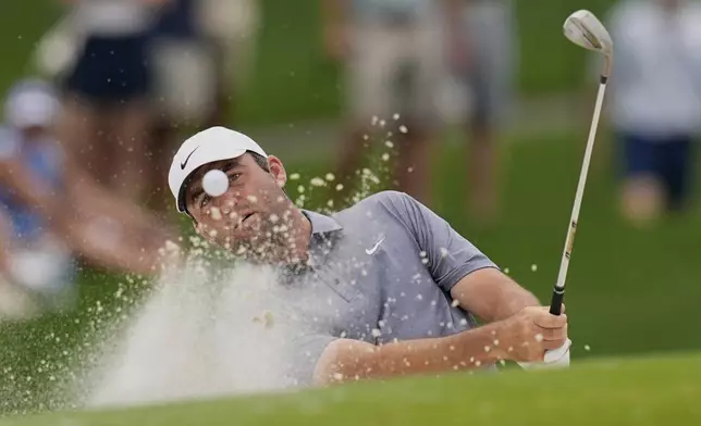 Scottie Scheffler hits from the bunker on the fourth hole during the second round of the PGA Championship golf tournament at the Quail Hollow Club, Friday, May 16, 2025, in Charlotte, N.C. (AP Photo/David J. Phillip)