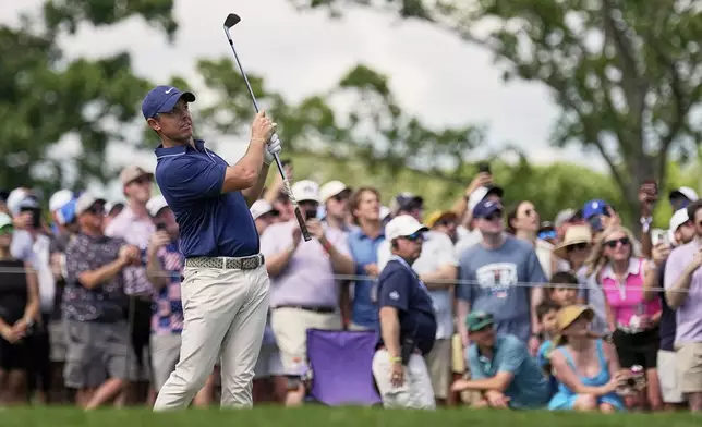 Rory McIlroy, of Northern Ireland, watches his tee shot on the 17th hole during the third round of the PGA Championship golf tournament at the Quail Hollow Club, Saturday, May 17, 2025, in Charlotte, N.C. (AP Photo/George Walker IV)