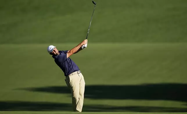 Scottie Scheffler hits from the fairway on the 15th hole during the final round of the PGA Championship golf tournament at the Quail Hollow Club, Sunday, May 18, 2025, in Charlotte, N.C. (AP Photo/David J. Phillip)