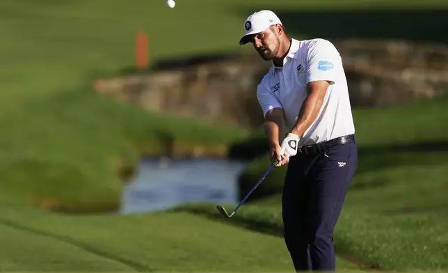 Bryson DeChambeau chips to the green on the 18th hole during the third round of the PGA Championship golf tournament at the Quail Hollow Club, Saturday, May 17, 2025, in Charlotte, N.C. (AP Photo/Matt York)