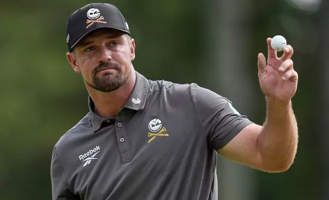 Bryson DeChambeau waves after making a putt on the ninth hole during the first round of the PGA Championship golf tournament at the Quail Hollow Club, Thursday, May 15, 2025, in Charlotte, N.C. (AP Photo/George Walker IV)