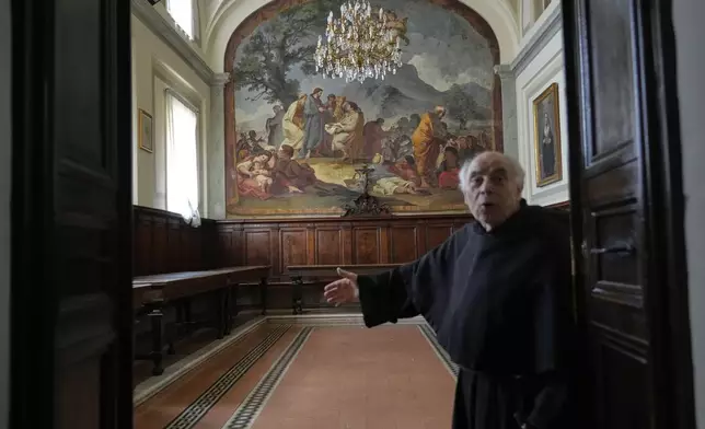 Augustinian friar Paolo Angelone shows the refectory of the Sanctuary of Our Mother of Good Counsel with a fresco by Taddeo Conza depicting the Miracle of the Loaves and Fishes, during an interview in Genazzano, Italy, Thursday, May 15, 2025. (AP Photo/Gregorio Borgia)
