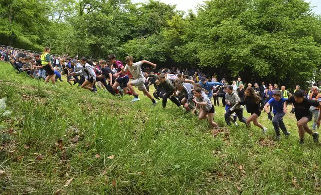 Children under 11 start for the uphill competition during the traditional annual Cheese Rolling contest at Cooper's Hill in Brockworth, Gloucestershire, England, Monday, May 26, 2025.(AP Photo/Anthony Upton)