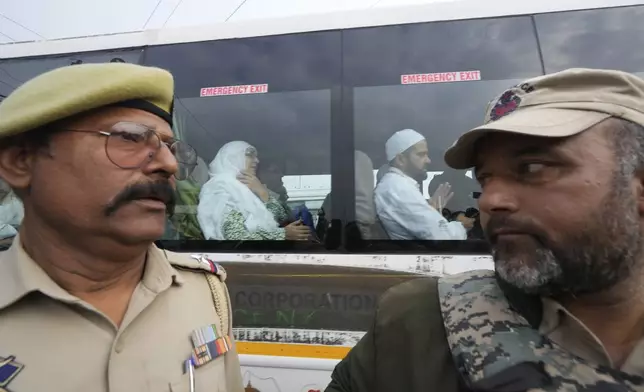 Indian policemen guard as the first batch of Kashmiri Muslim pilgrims, departs for the annual pilgrimage to Mecca, Islam's holiest site, in Srinagar, Indian-controlled Kashmir, Sunday, May 4, 2025. (AP Photo/Mukhtar Khan)