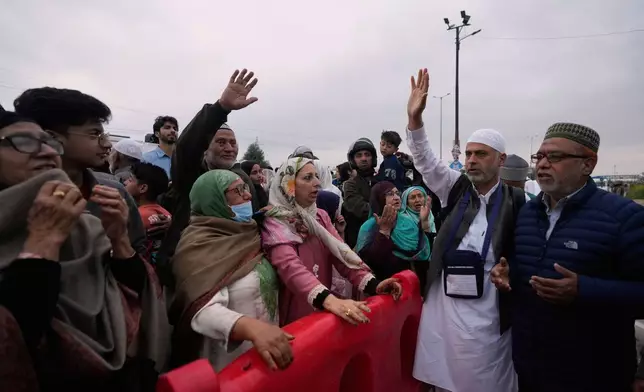 Kashmiri Muslim pilgrims wave to relatives and others as the first batch departs for the annual pilgrimage to Mecca, Islam's holiest site, in Srinagar, Indian-controlled Kashmir, Sunday, May 4, 2025. (AP Photo/Mukhtar Khan)