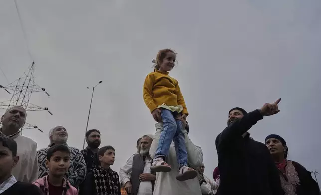 Family member and relatives of Hajj pilgrims see off them as the first batch departs for the annual pilgrimage to Mecca, Islam's holiest site, in Srinagar, Indian-controlled Kashmir, Sunday, May 4, 2025. (AP Photo/Mukhtar Khan)