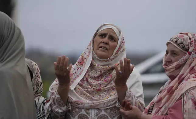 A Kashmiri woman prays as the first batch of Muslim pilgrims, departs for the annual pilgrimage to Mecca, Islam's holiest site, in Srinagar, Indian-controlled Kashmir, Sunday, May 4, 2025. (AP Photo/Mukhtar Khan)