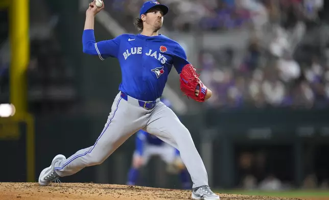 Toronto Blue Jays starting pitcher Kevin Gausman throws a pitch to the Texas Rangers during the eighth inning of a baseball game, Monday, May 26, 2025, in Arlington, Texas. (AP Photo/Julio Cortez)