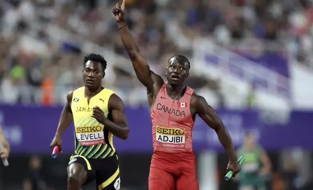 Canadian sprinter Eliezer Adjibi, right, celebrates after winning in the 4x100 meters mixed relay at the World Athletics Relays, in Guangzhou in south China's Guangdong province on Sunday, May 11, 2025. (Chinatopix Via AP)