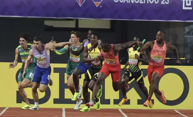 Athletes exchange the baton during the men's 4x100 meter relay at the World Athletics Relays, in Guangzhou in south China's Guangdong province on Sunday, May 11, 2025. (Chinatopix Via AP)