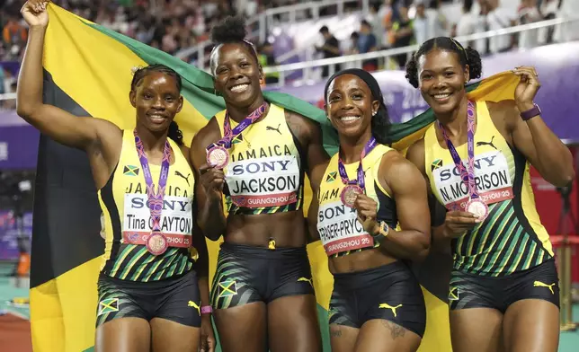 Jamaican sprinters from left, Tina Clayton, Shericka Jackson, Shelly-Ann Fraser-Pryce, and Natasha Morrison celebrate after winning the bronze medals in women's 4x100 meters relay at the World Athletics Relays, in Guangzhou in south China's Guangdong province, Sunday, May 11, 2025. (Chinatopix Via AP)
