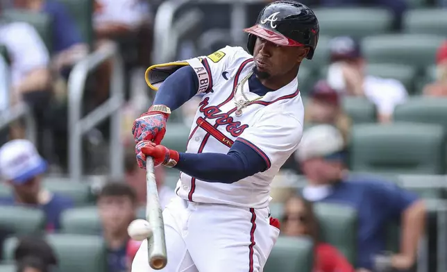 Atlanta Braves' Ozzie Albies hits an RBI double in the second inning of a baseball game against the San Diego Padres, Sunday, May 25, 2025, in Atlanta. (AP Photo/Colin Hubbard)