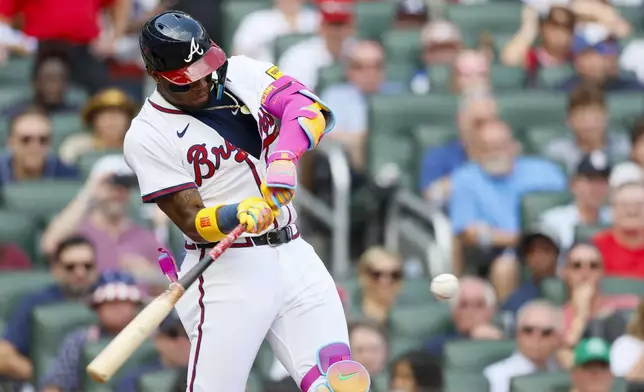 Atlanta Braves' Ronald Acuña Jr. (13) connects the ball for a double during the fifth inning of a baseball game against the San Diego Padres on Sunday, May 25, 2025, in Atlanta. (Miguel Martinez/Atlanta Journal-Constitution via AP)