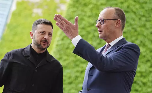 German Chancellor Friedrich Merz, right, welcomes Ukrainian President Volodymyr Zelenskyy for a meeting in Berlin, Germany, Wednesday, May 28, 2025. (Kay Nietfeld/dpa via AP)