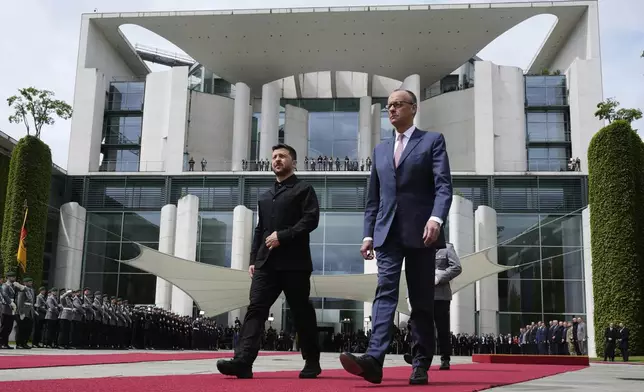 Germany's Chancellor Friedrich Merz, right, welcomes Ukraine's President Volodymyr Zelenskyy during an official military reception at the chancellery in Berlin, Germany, Wednesday, May 28, 2025.(AP Photo/Markus Schreiber)