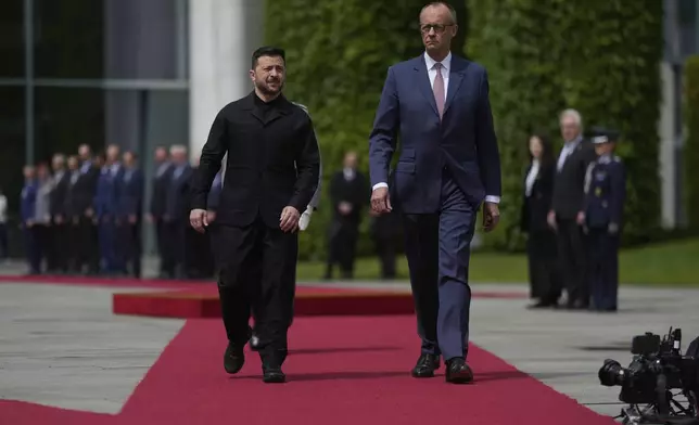 Germany's Chancellor Friedrich Merz, right, welcomes Ukraine's President Volodymyr Zelenskyy during an official military reception at the chancellery in Berlin, Germany, Wednesday, May 28, 2025.(AP Photo/Markus Schreiber)