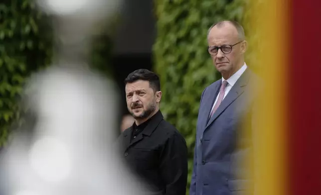 Germany's Chancellor Friedrich Merz, right, welcomes Ukraine's President Volodymyr Zelenskyy during an official military reception at the chancellery in Berlin, Germany, Wednesday, May 28, 2025.(AP Photo/Markus Schreiber)