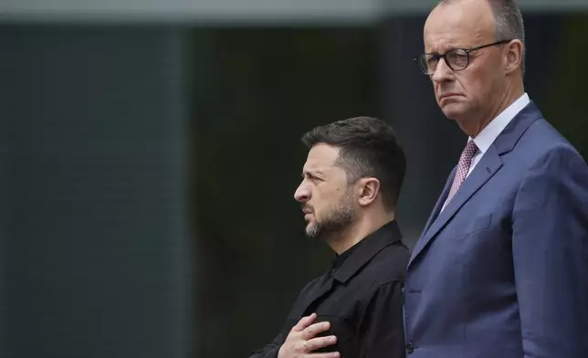 Germany's Chancellor Friedrich Merz, right, welcomes Ukraine's President Volodymyr Zelenskyy during an official military reception at the chancellery in Berlin, Germany, Wednesday, May 28, 2025.(AP Photo/Markus Schreiber)