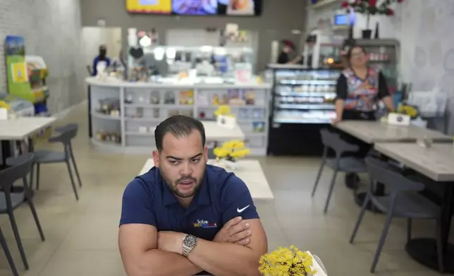 Wilmer Escaray talks about his concerns about the future of his employees and customers during an interview inside a franchise of "Sabor Venezolano," one of 18 businesses he owns which employ scores of Venezuelan immigrants with Temporary Protected Status (TPS) who are now potentially exposed to deportation, in Doral, Fla., Tuesday, May 20, 2025. (AP Photo/Rebecca Blackwell)