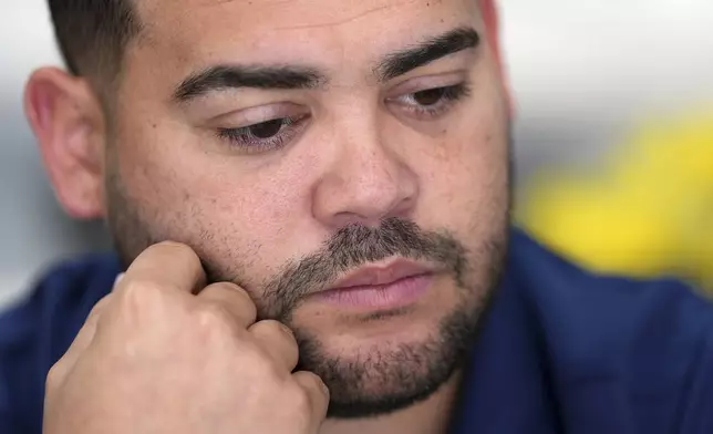 Wilmer Escaray reflects on the future of his employees and customers during an interview inside a franchise of "Sabor Venezolano," one of 18 businesses he owns which employ scores of Venezuelan immigrants with Temporary Protected Status (TPS) who are now potentially exposed to deportation, in Doral, Fla., Tuesday, May 20, 2025. (AP Photo/Rebecca Blackwell)