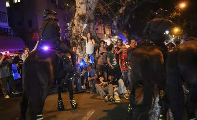 Israeli mounted police disperse demonstrators blocking a road during a protest marking 600 days since Israeli hostages were taken by Hamas into the Gaza Strip, call for their release and an end to the war, in Tel Aviv, Israel, on Wednesday, May 28, 2025. (AP Photo/Ohad Zwigenberg)