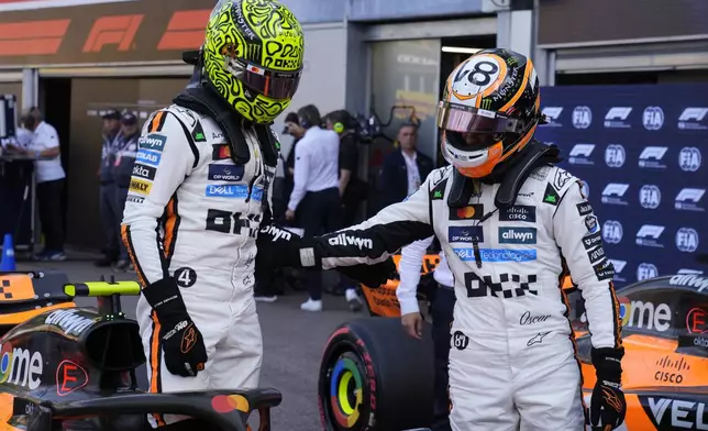 McLaren driver Oscar Piastri of Australia, right, congratulates McLaren driver Lando Norris of Britain for his pole position after the qualifying session ahead of the Formula One Monaco Grand Prix race at the Monaco racetrack in Monaco, Saturday, May 24, 2025. (AP Photo/Manu Fernandez)